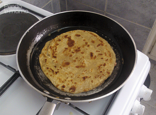 warm some margarine on a frying pan and spread it out, place the coated chapati on it upside down so that the sausage side cooks first