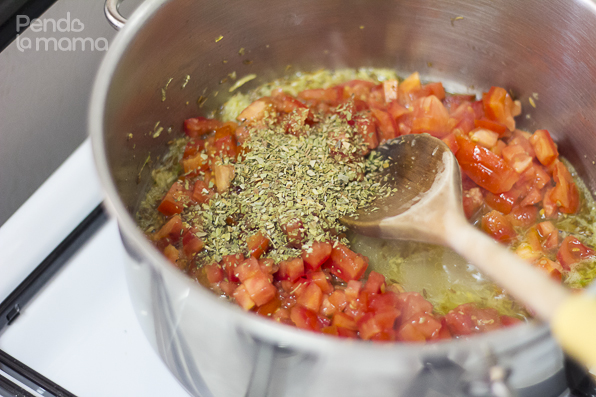 then add the chopped tomatoes and oregano, let that simmer for a minute,...