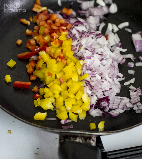 then in a medium sized frying pan, heat up the cooking oil a bit and add the onions and peppers. 