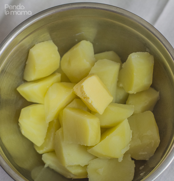 add a chunky piece of butter and mix with a spoon while the potatoes are still hot so that the butter melts and coats the potatoes