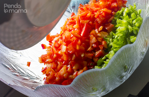 then cut up the red and green peppers and place in a large mixing bowl with the cherry tomatoes and dhania